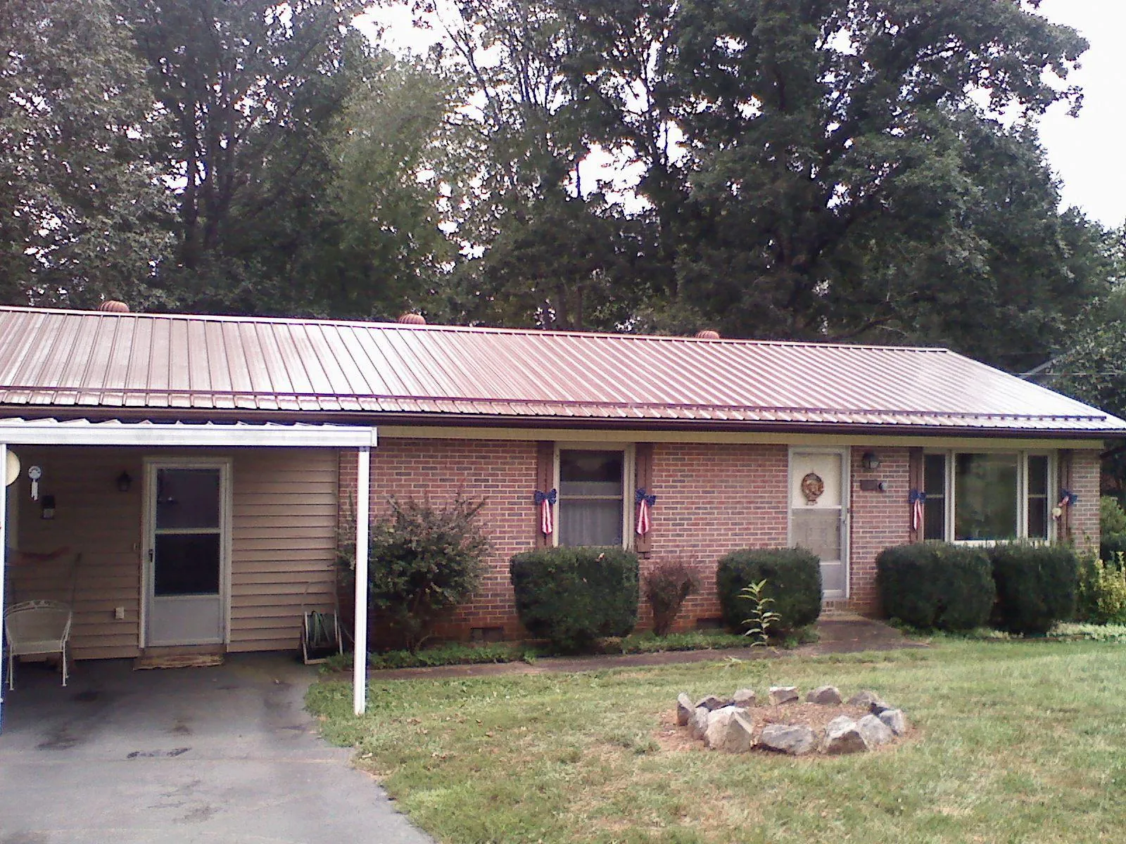 Bronze metal roof and carport on a brick ranch home — Roof Repair work by our crew in Oakland
